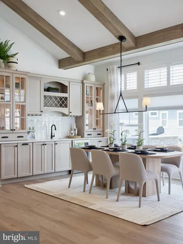 a kitchen with a table chairs sink and cabinets