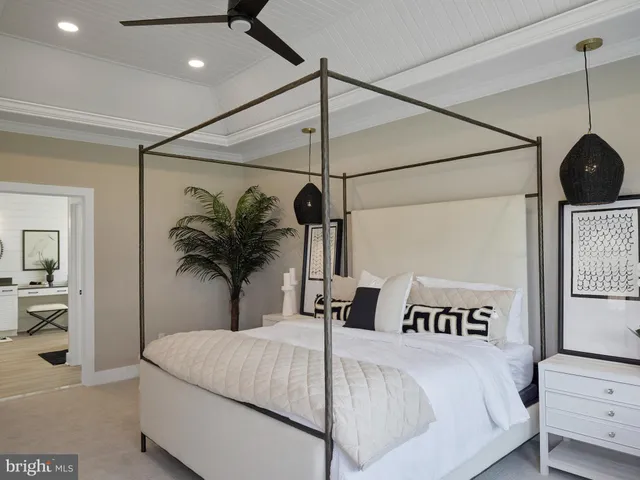 a bedroom with a large bed and a chandelier