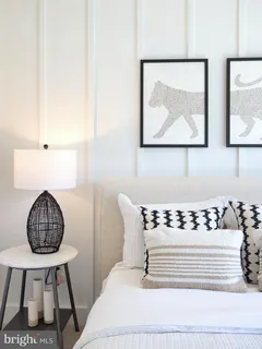 a bedroom with a bed dresser and a window