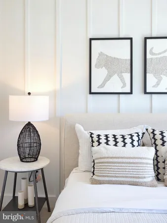 a bedroom with a bed dresser and a window