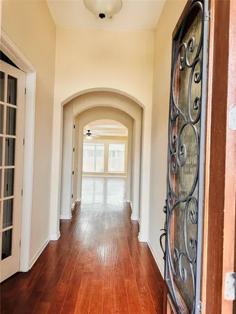 a view of a hallway with wooden floor