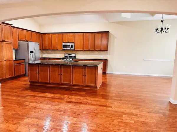 a kitchen with stainless steel appliances granite countertop a sink and cabinets