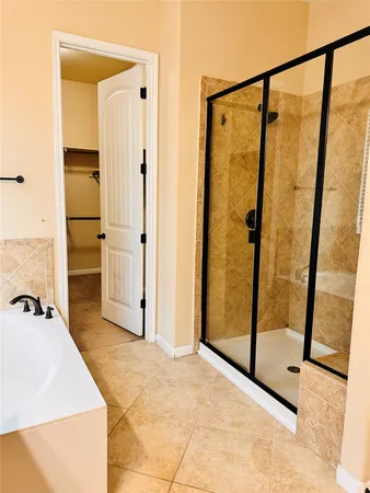 a bathroom with a tub and a shower