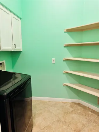 a kitchen with a refrigerator and a cabinets