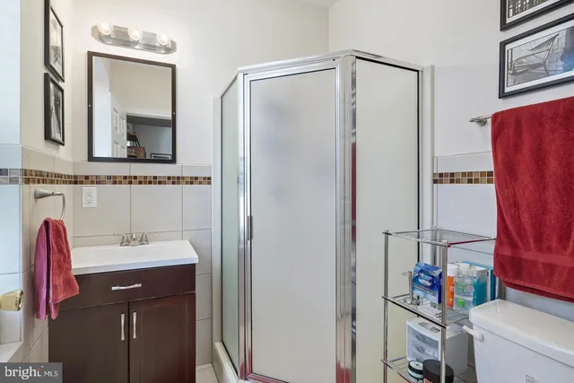 a bathroom with a sink vanity and a mirror