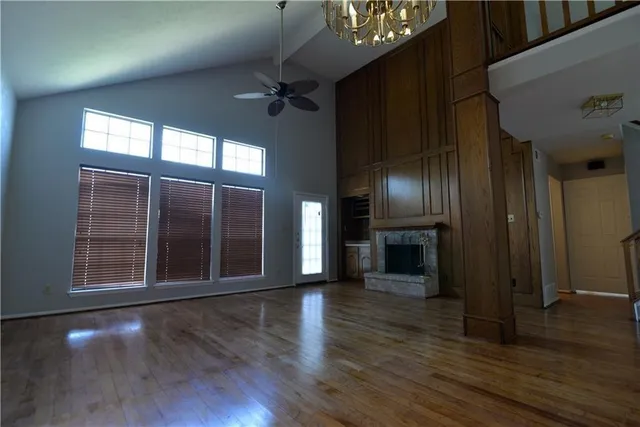 wooden floor in an empty room with a fireplace