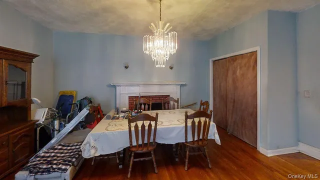 a view of a dining room with furniture a chandelier and wooden floor
