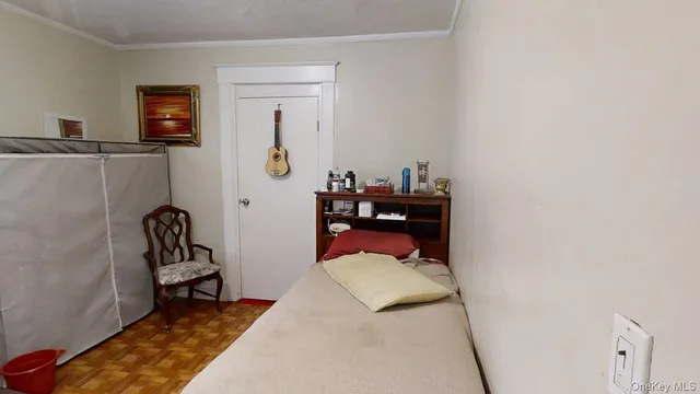 a bedroom with a bed and lounge chair