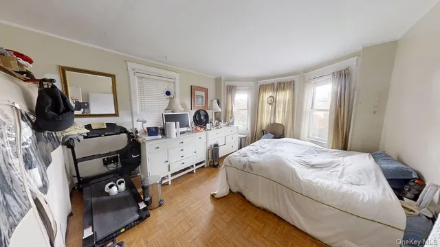 a bedroom with bed and window