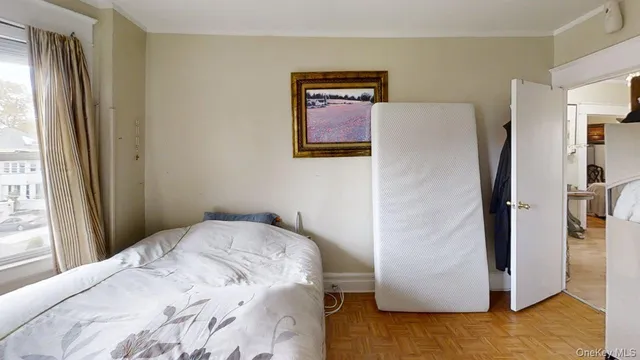 a bedroom with a bed and a refrigerator
