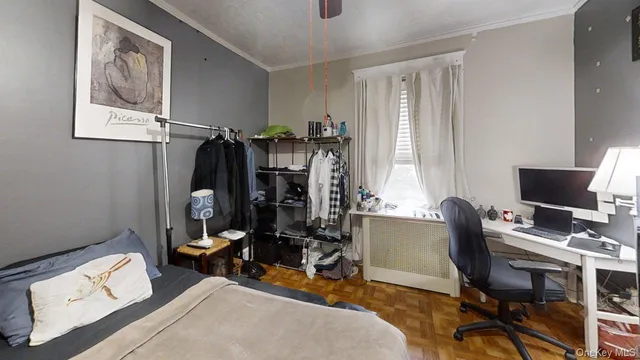 a view of a workspace with furniture and a window