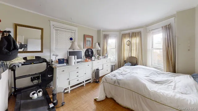 a bedroom with a bed and a dresser in it