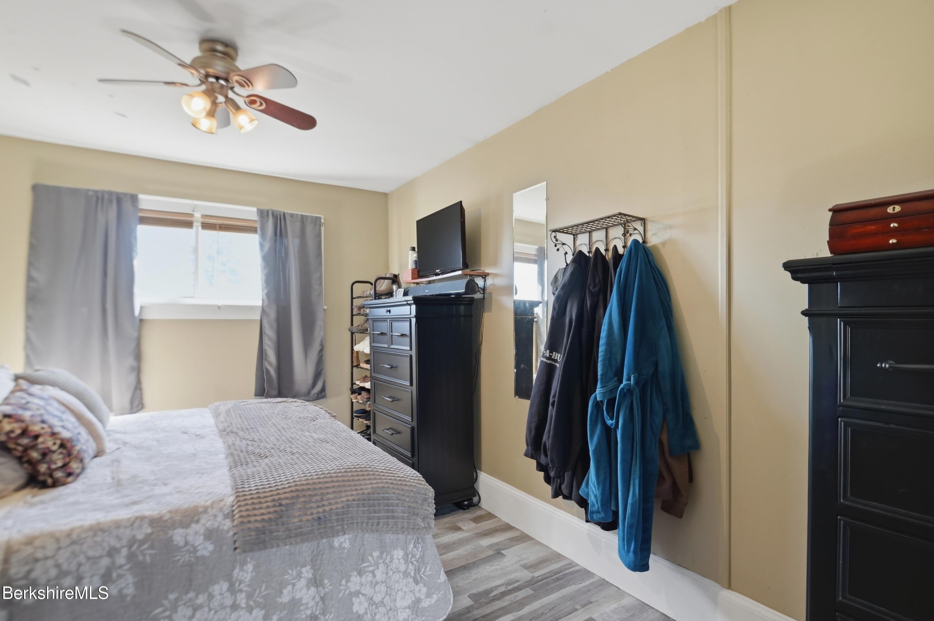 22 Broadway Street Pittsfield, MA 01201 - Photo 68 of 84 a bedroom with a bed and a chandelier