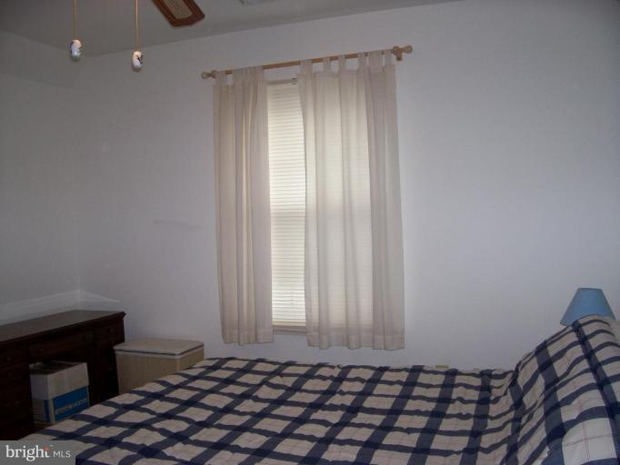 206 Oakwood Road Edgewater, MD 21037 - Photo 5 of 12 a bedroom with a bed and a window