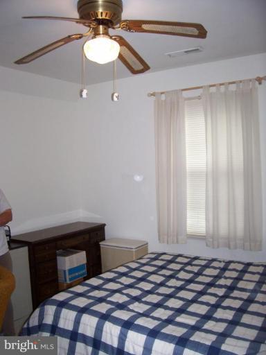 206 Oakwood Road Edgewater, MD 21037 - Photo 6 of 12 a bedroom with a bed and a chandelier