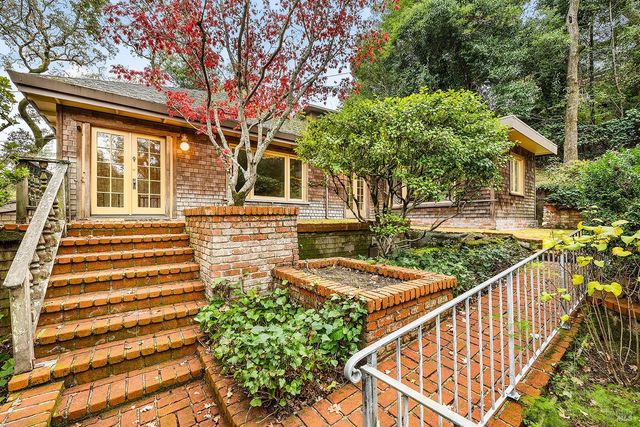 a view of a house with backyard and deck