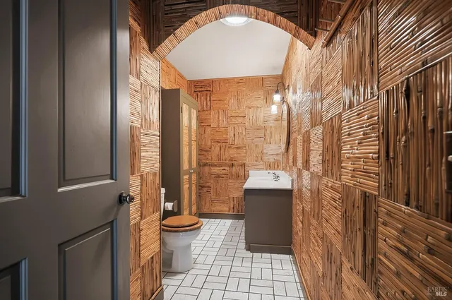 a view of an empty room with a window and fireplace