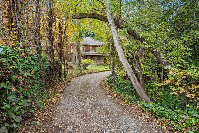 a front view of a house with a yard and shrubs
