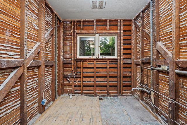 a view of an empty room with a window and tub