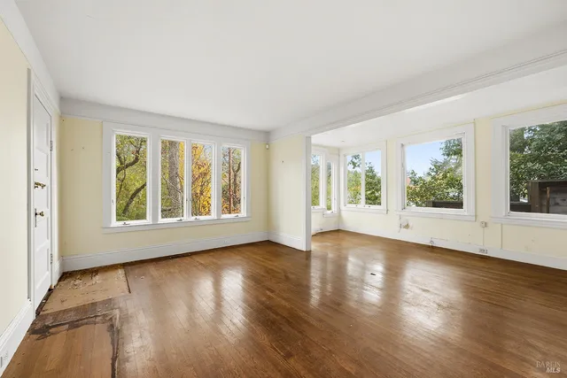 a view of an entryway with wooden floor and windows