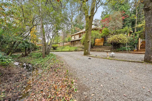 a view of a backyard with patio and fire pit