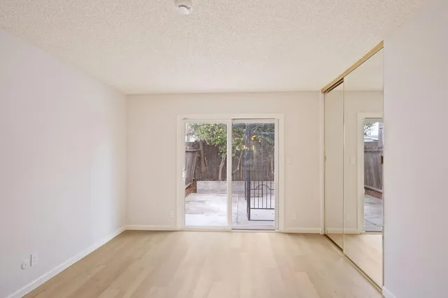 an empty room with sliding glass door and shower