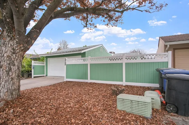 a backyard of a house with table and chairs
