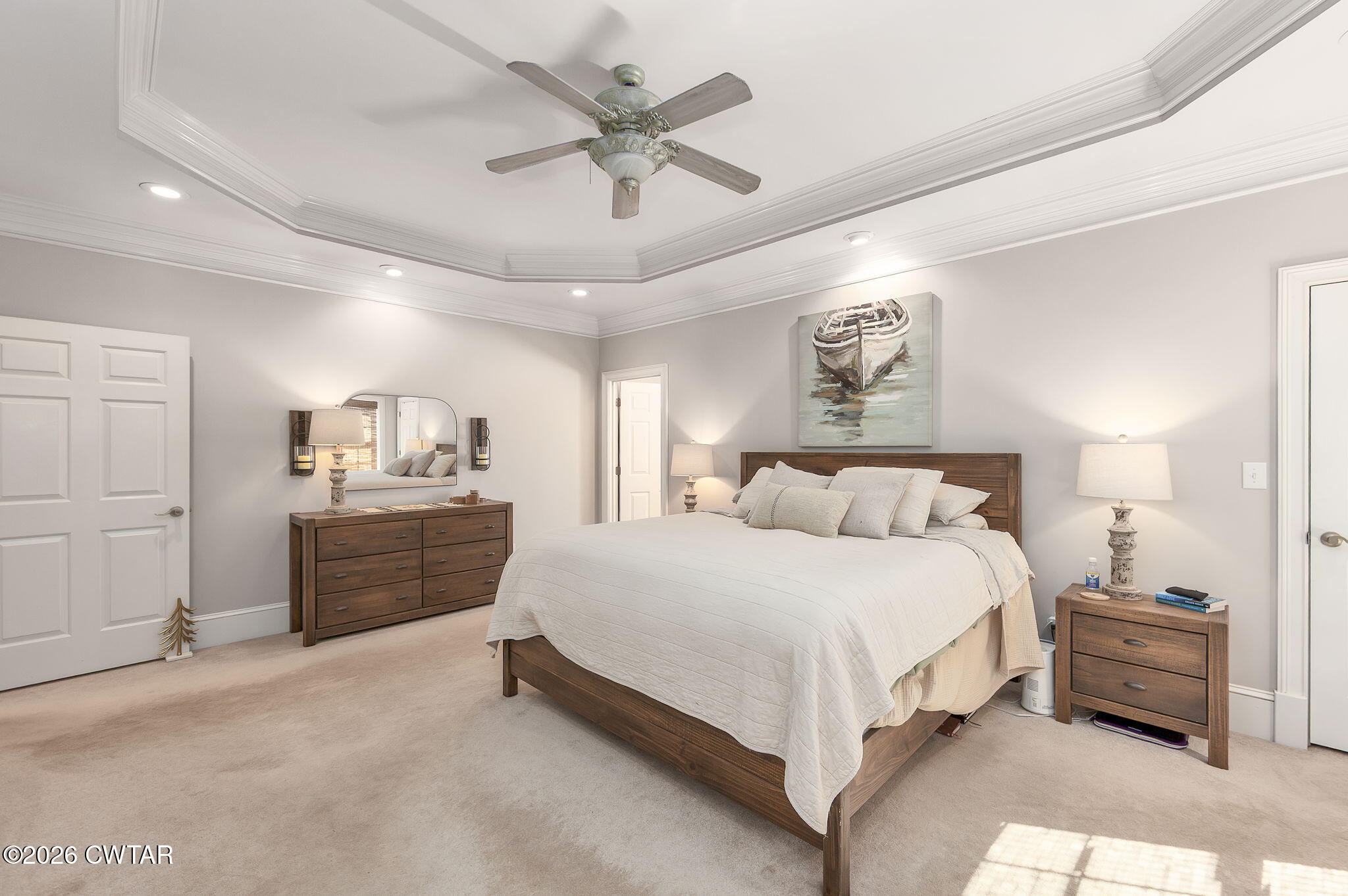 4320 Timberlake-Wildersville Road Lexington, TN 38351 - Photo 17 of 58 a spacious bedroom with a bed a dresser and a chandelier