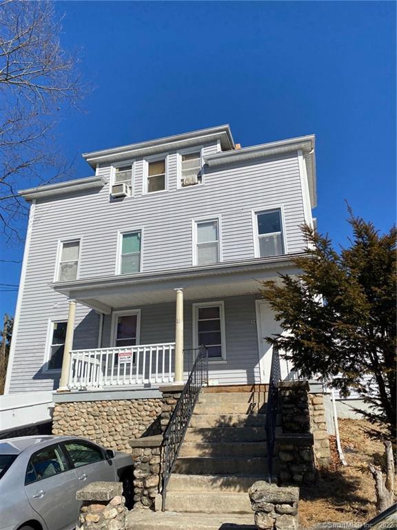 a front view of a house with parking space