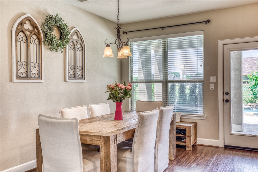 586 Ruby Drive Bellville, TX 77418 - Photo 11 of 50 a view of a dining room with furniture window and wooden floor