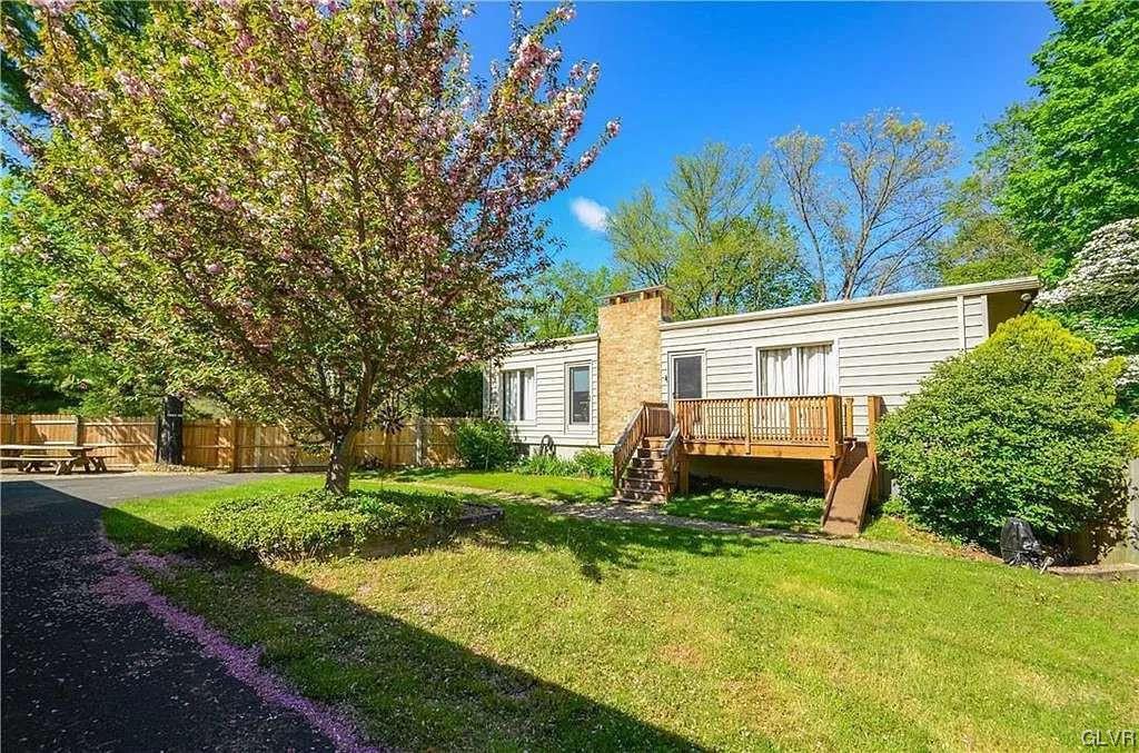 2936 River Road Mount Bethel, PA 18343 - Photo 16 of 20 a front view of a house with a yard and trees