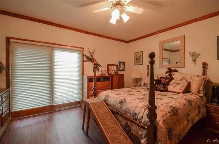 2936 River Road Mount Bethel, PA 18343 - Photo 18 of 20 a bedroom with a bed and a chandelier