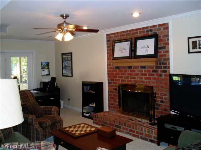 8052 Glengarriff Road Clemmons, NC 27012 - Photo 15 of 16 Den/Family/Great Room. Daylite walkout to extened patio and fire pit area. Lower level family room has wet bar, full bath, and brick fire place.