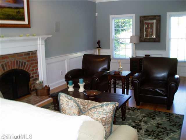 8052 Glengarriff Road Clemmons, NC 27012 - Photo 9 of 16 Living Room. Crown molding, chair rail, shadow box accents, brick fire place w/toddler friendly hearth with mantle. Recessed and can lights, Ceiling fan w/remote. Large and roomy.