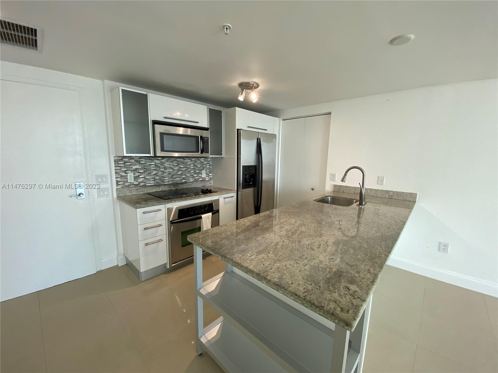 185 Southwest 7th Street, Unit 4110 Miami, FL 33130 - Photo 1 of 14 a kitchen with a stove and a sink