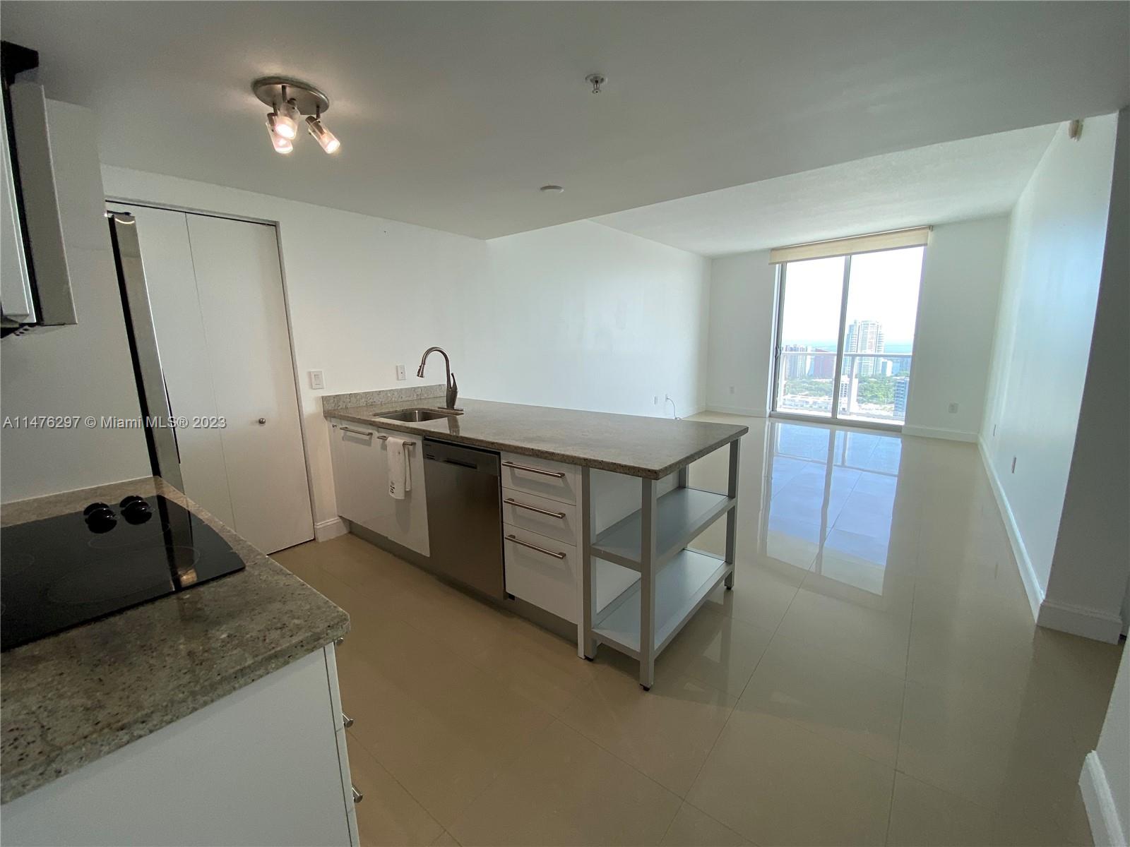 185 Southwest 7th Street, Unit 4110 Miami, FL 33130 - Photo 5 of 14 a kitchen that has a sink and a stove in it