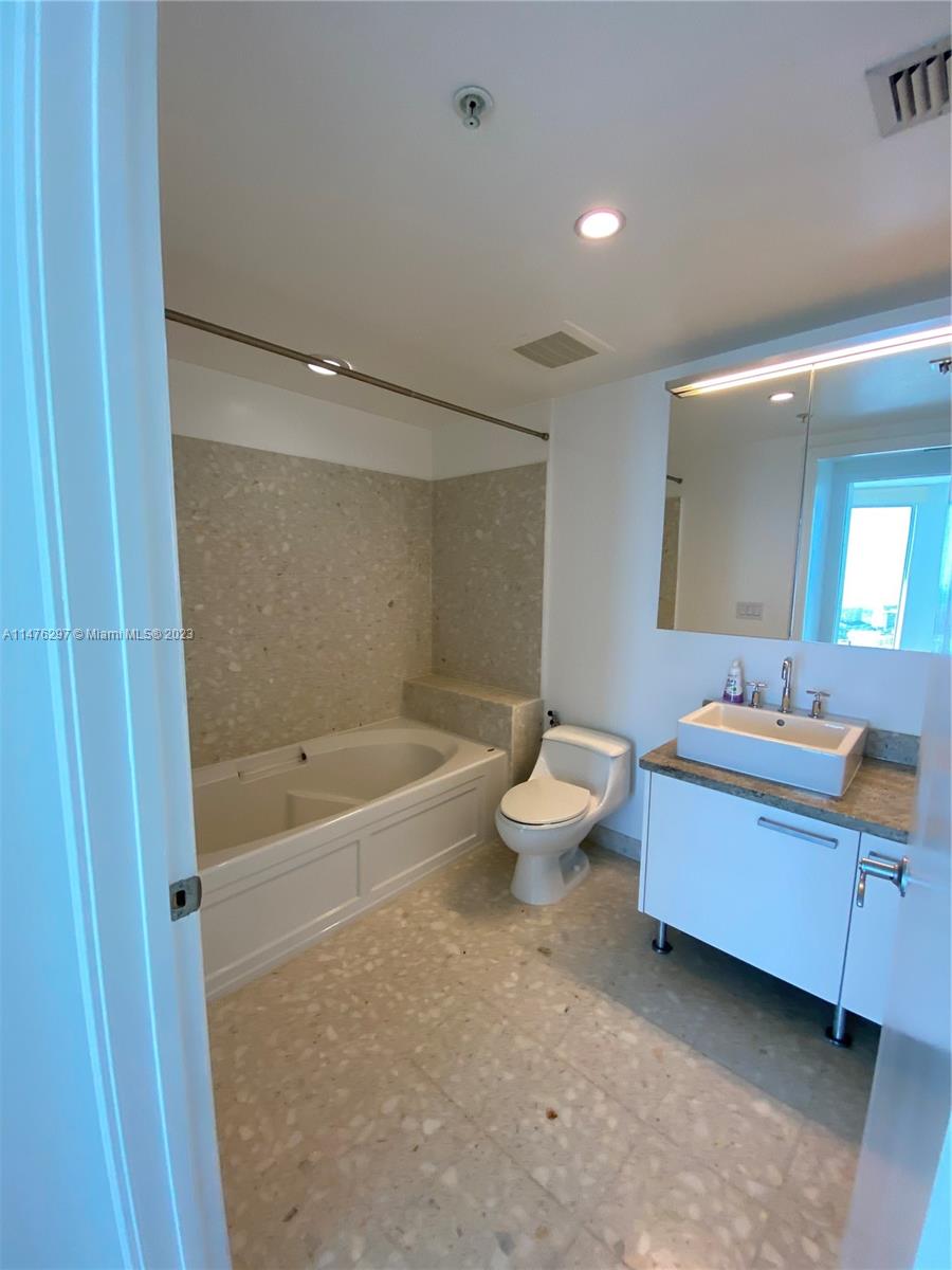 185 Southwest 7th Street, Unit 4110 Miami, FL 33130 - Photo 6 of 14 a bathroom with a bathtub sink and toilet