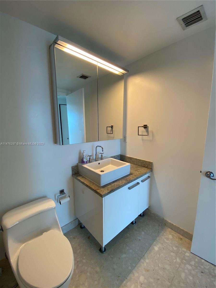 185 Southwest 7th Street, Unit 4110 Miami, FL 33130 - Photo 7 of 14 a bathroom with a sink and a mirror
