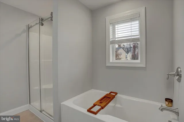 a view of a house with a backyard and a tree