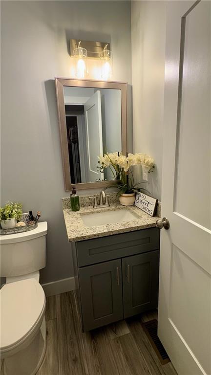 566 Clinton Drive Temple, GA 30179 - Photo 14 of 40 a bathroom with a toilet sink and mirror