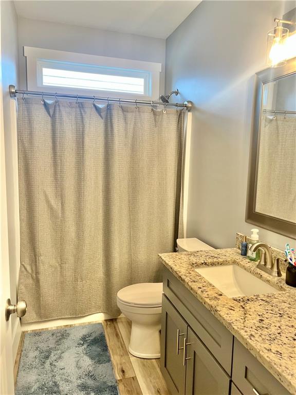 566 Clinton Drive Temple, GA 30179 - Photo 22 of 40 a bathroom with a granite countertop sink toilet and a mirror