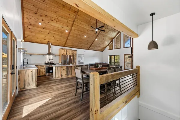 a open kitchen with stainless steel appliances granite countertop a stove and a refrigerator