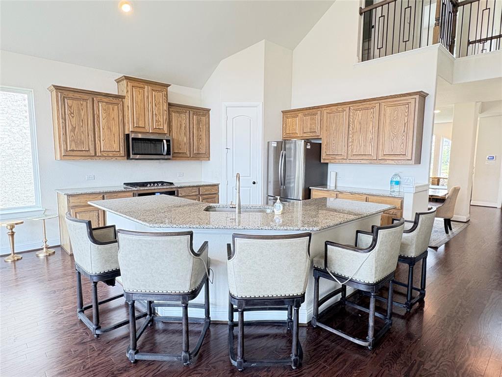 323 Butternut Way Irving, TX 75063 - Photo 12 of 32 a kitchen with a dining table chairs and a refrigerator