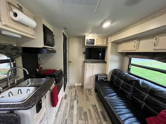 a living room with furniture gym equipment and a fireplace