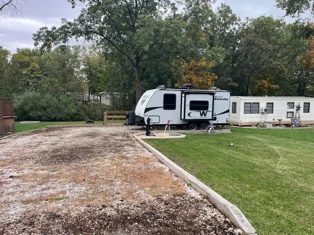 a view of a house with a big yard potted plants and large tree