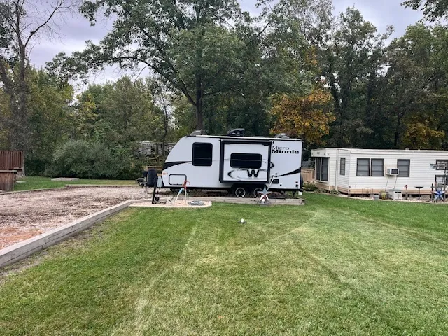 a view of a house with backyard and sitting area