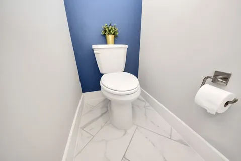 a white toilet sitting next to a white sink