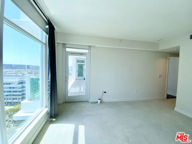 a view of an empty room and a window