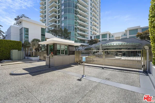 a view of a patio with a table and chairs under an umbrella