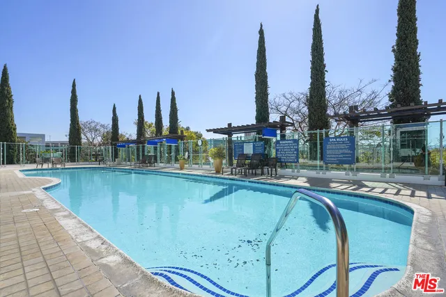 a view of a building with a swimming pool and sitting area